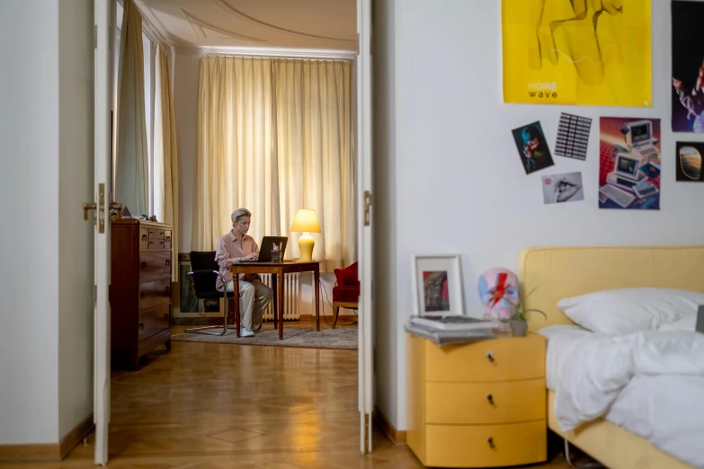 a man is working at his desk in the bedroom