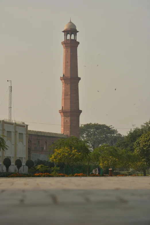 tall brick building with a clock in front of it