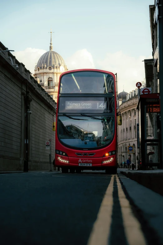 a double decker bus on street next to building