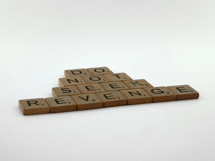 a wooden scrabble type block sitting on top of each other