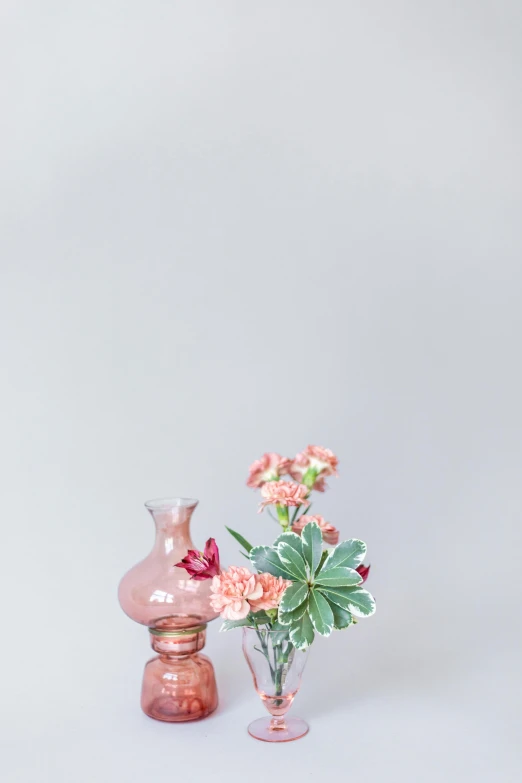 pink vases sit next to each other on a table