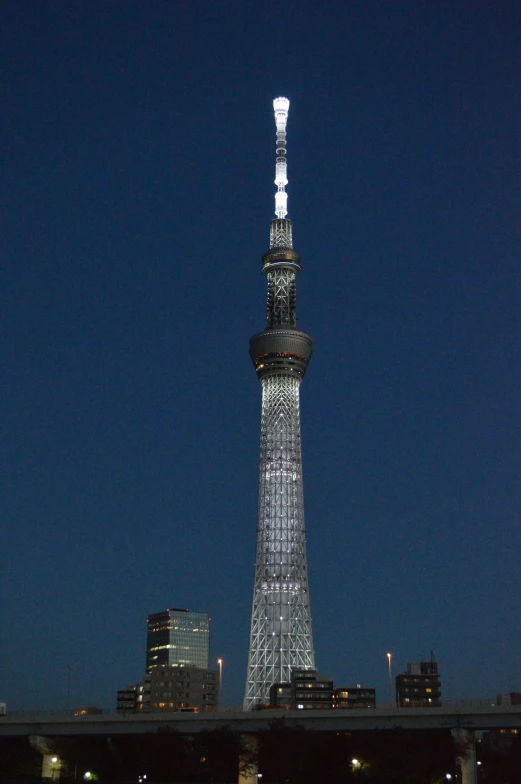 a very tall tower with a white light on it's side