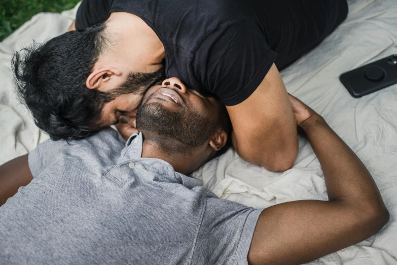 two men laying on top of each other