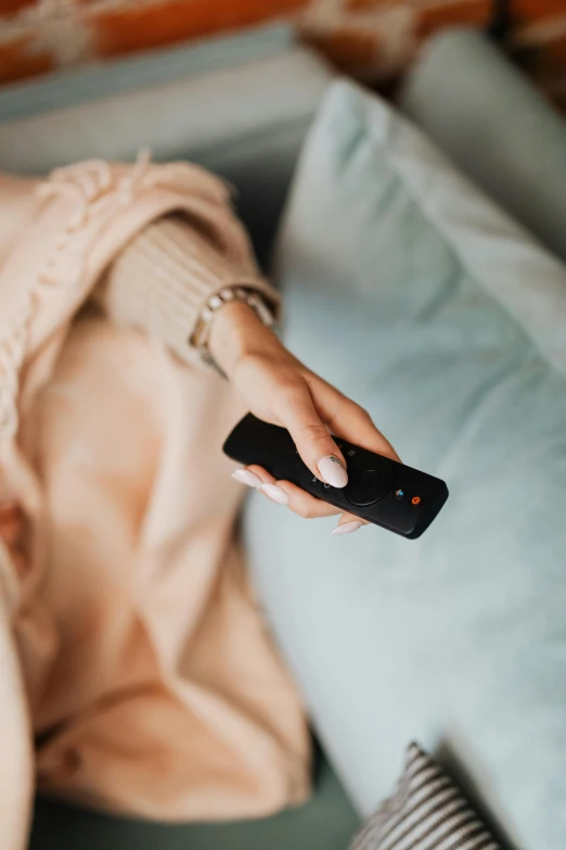 a woman holding a remote control in her hand