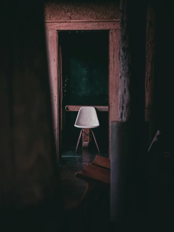 light at an open doorway onto a table and chair