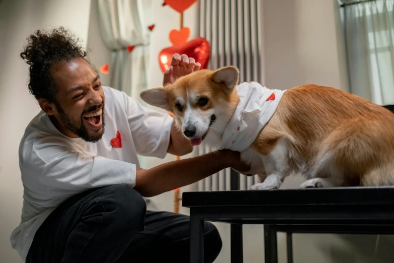 a man holding onto the side of his dog with its mouth open