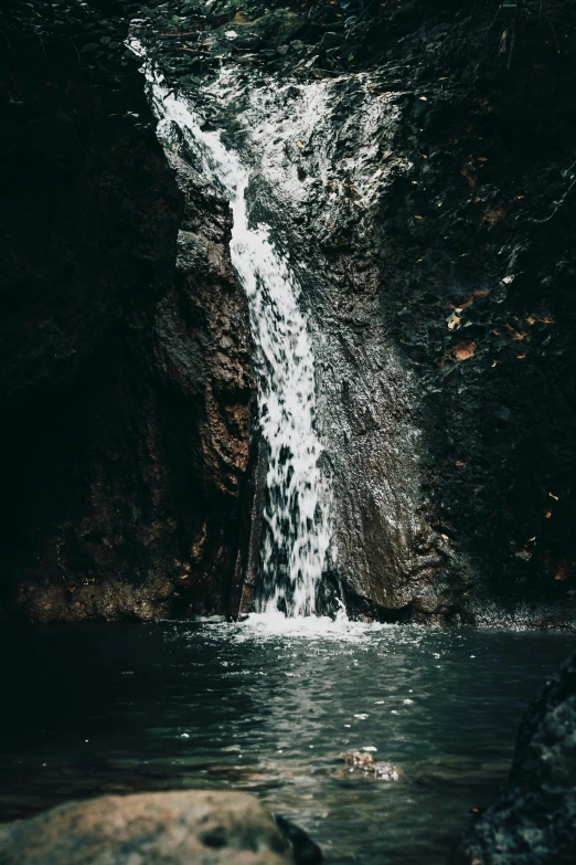 the waterfall is starting to fall down into the water