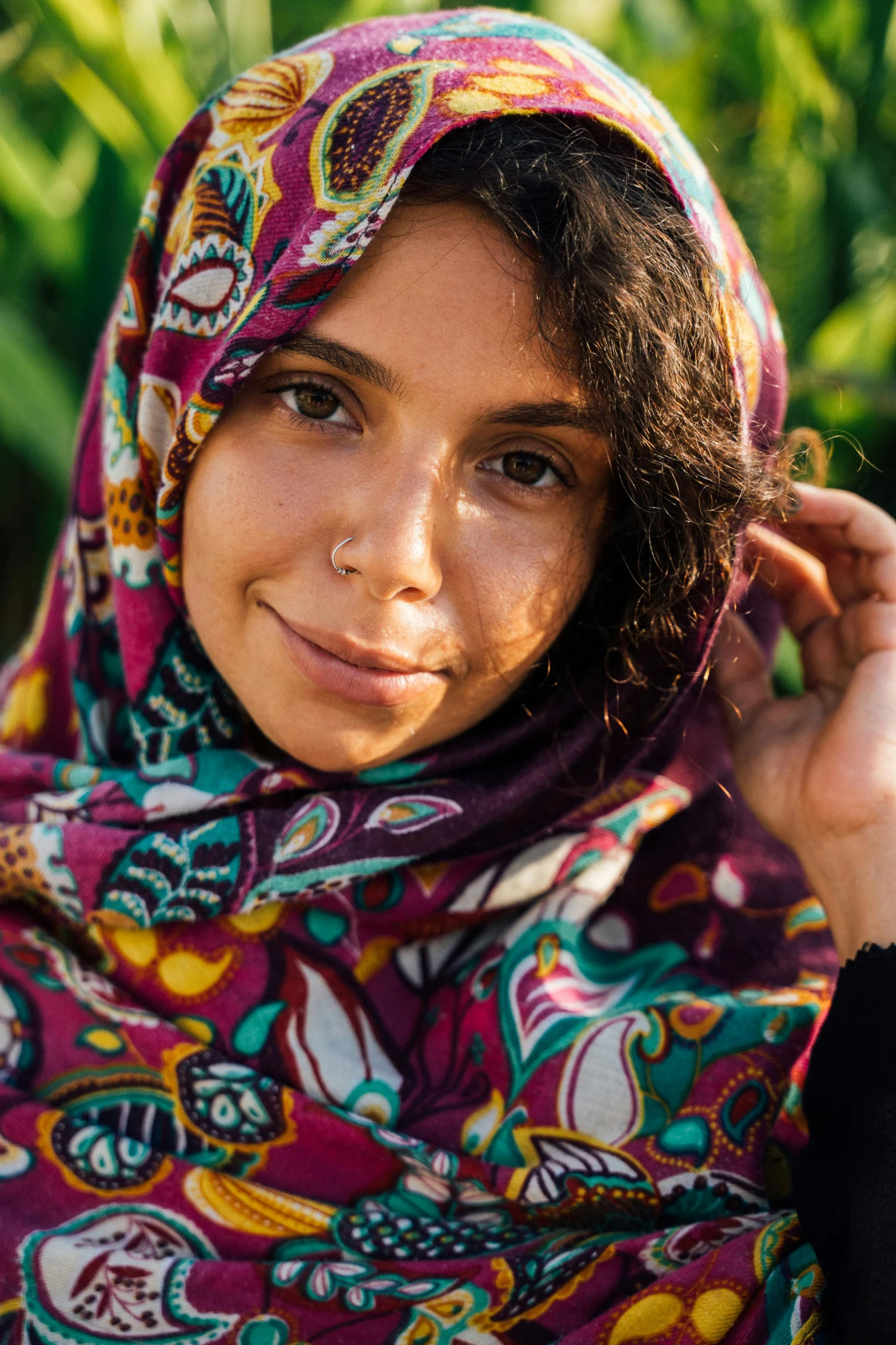  wearing a colorful scarf poses for a po