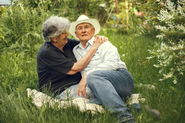 a woman and older man hugging and posing for the camera