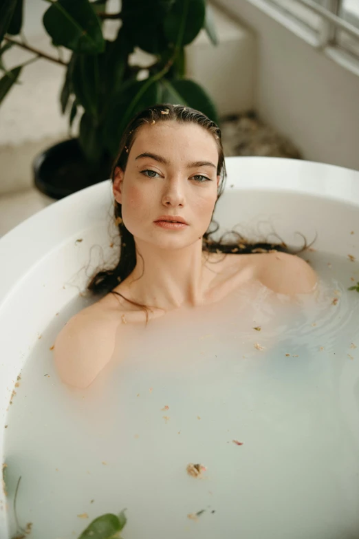 a woman standing in a bathtub filled with water