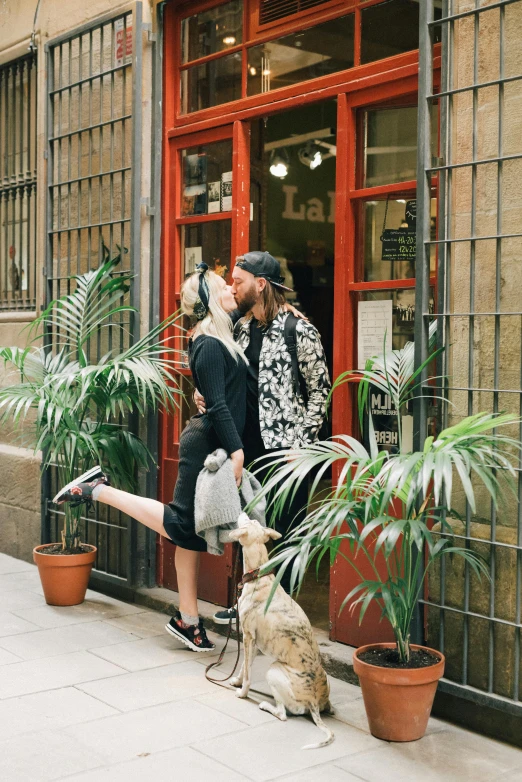 a man and woman kissing on the street