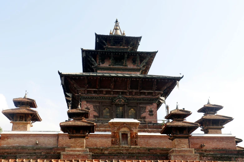 a very tall tower with some roof tops