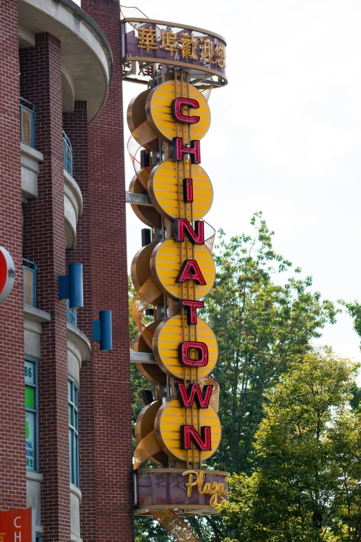 a tall building with a very large neon sign attached to the side of it
