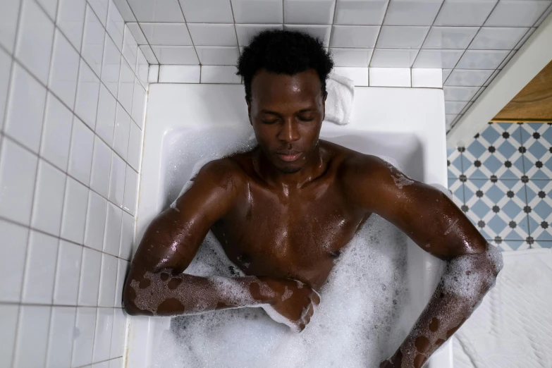 a man is playing in the bath tub with some soap