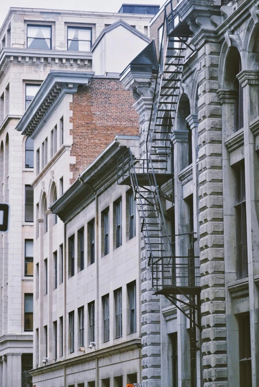 an old fire escape sitting next to some very old buildings