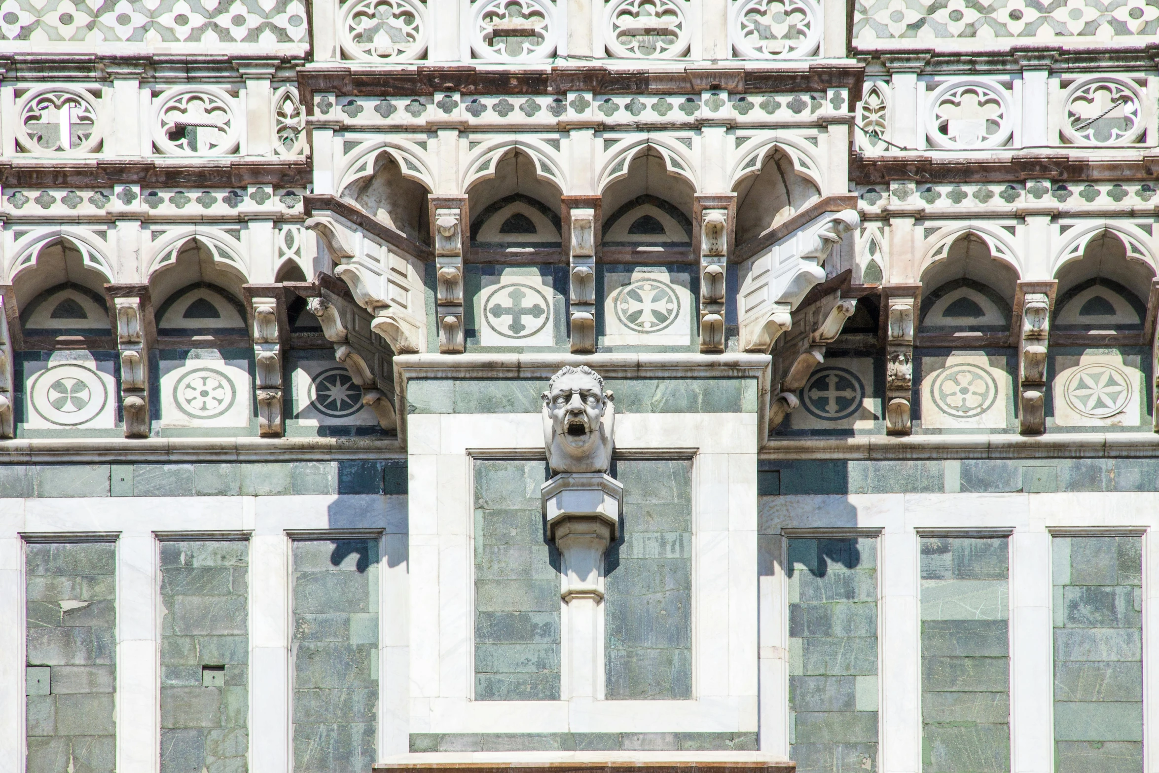 an architectural view of a building with multiple windows and two clock faces