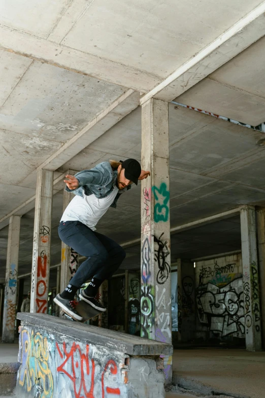 a skate boarder rides his board up the side of a cement ramp