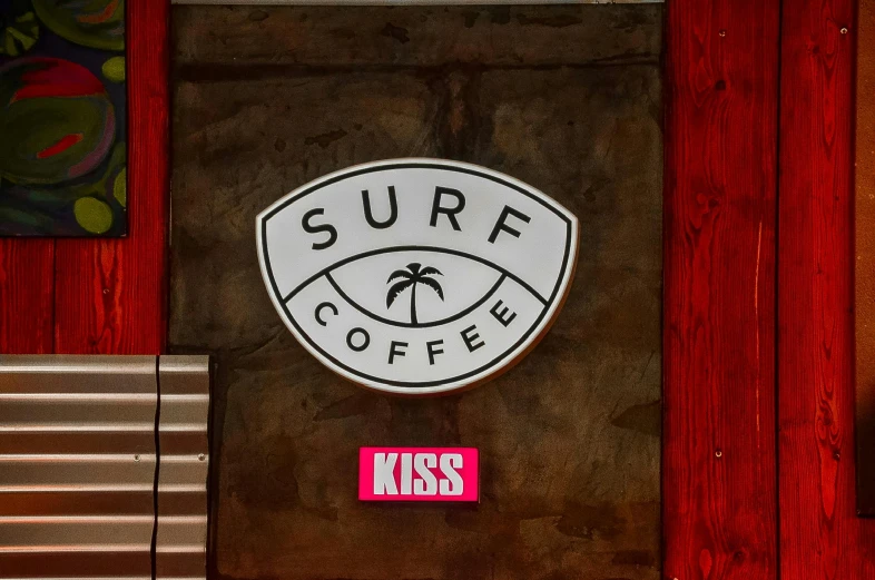 surf coffee sign with red wood walls and bench