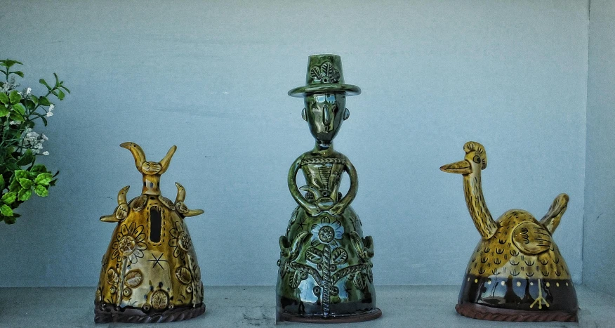 three bronze statues of animals and a clock