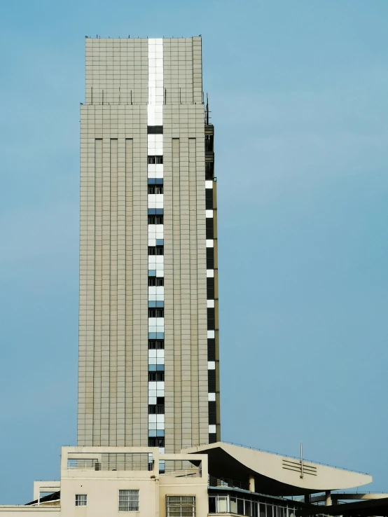 an airport jet flying past a tall building with windows