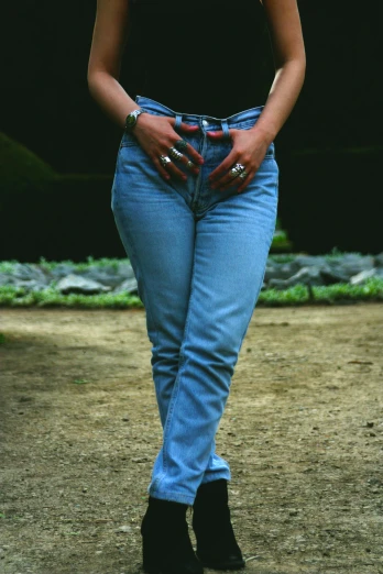 a close up of a woman's legs with jeans on