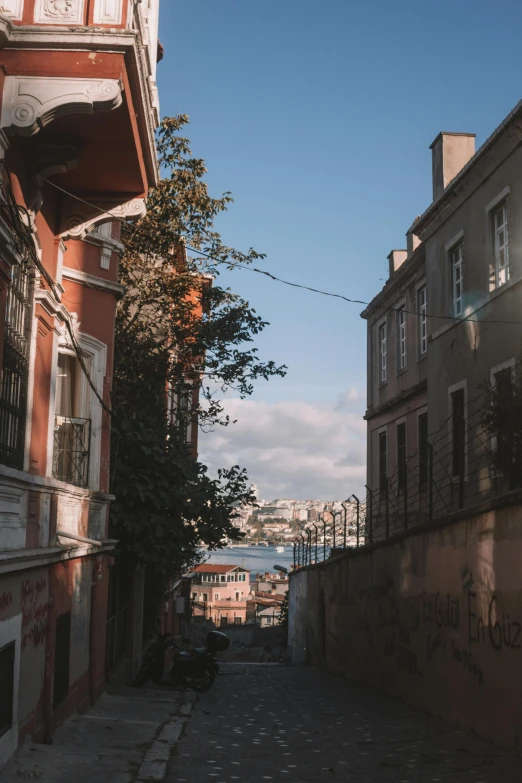 an old building has a bridge in the background