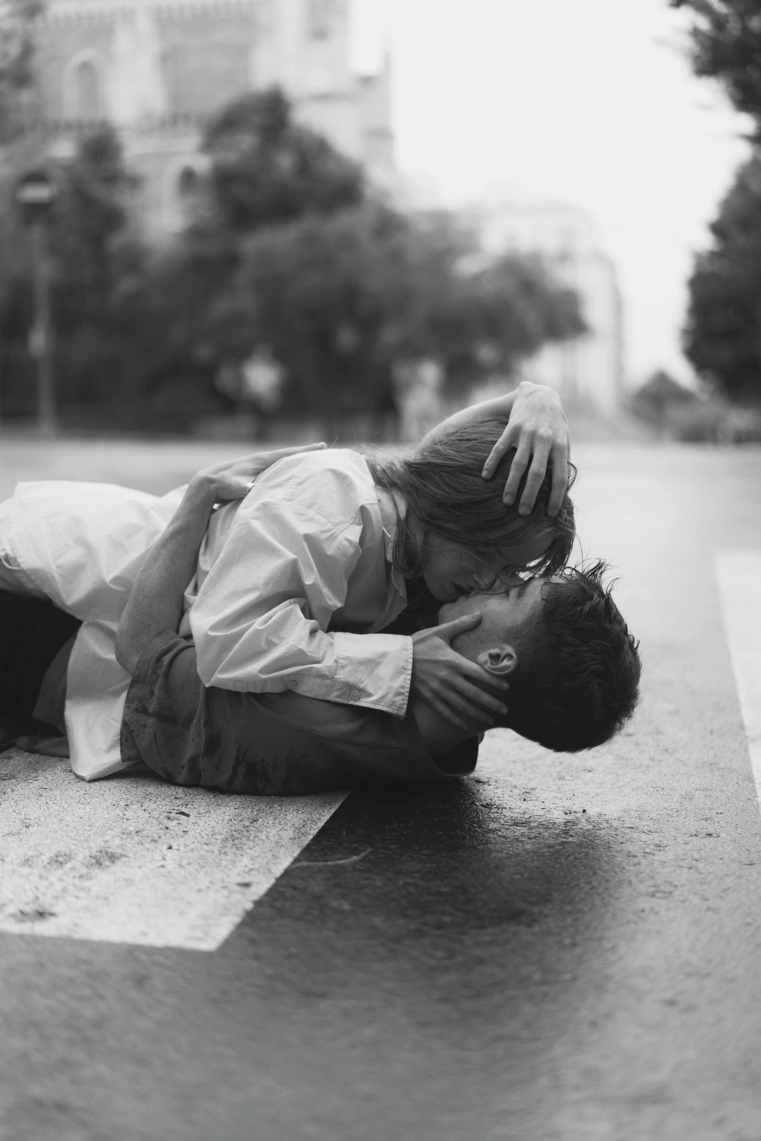 there is a woman who has fallen down on the sidewalk