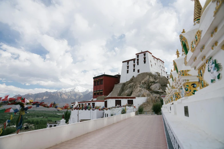 an elaborately painted building next to a rocky cliff