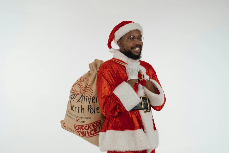 a black man dressed in christmas clothing holding a bag