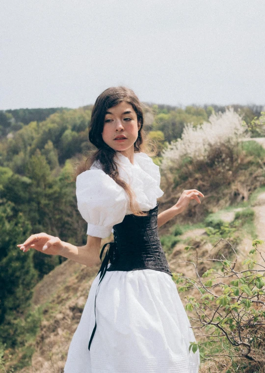 a woman in a white dress is dancing