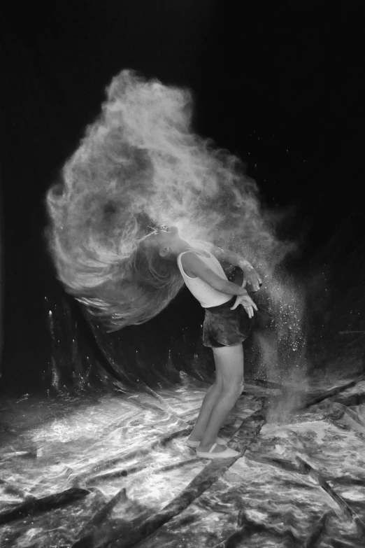 a woman is floating in the water next to some rocks