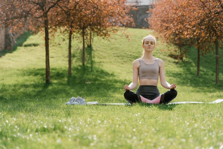 a woman in a yoga pose outdoors