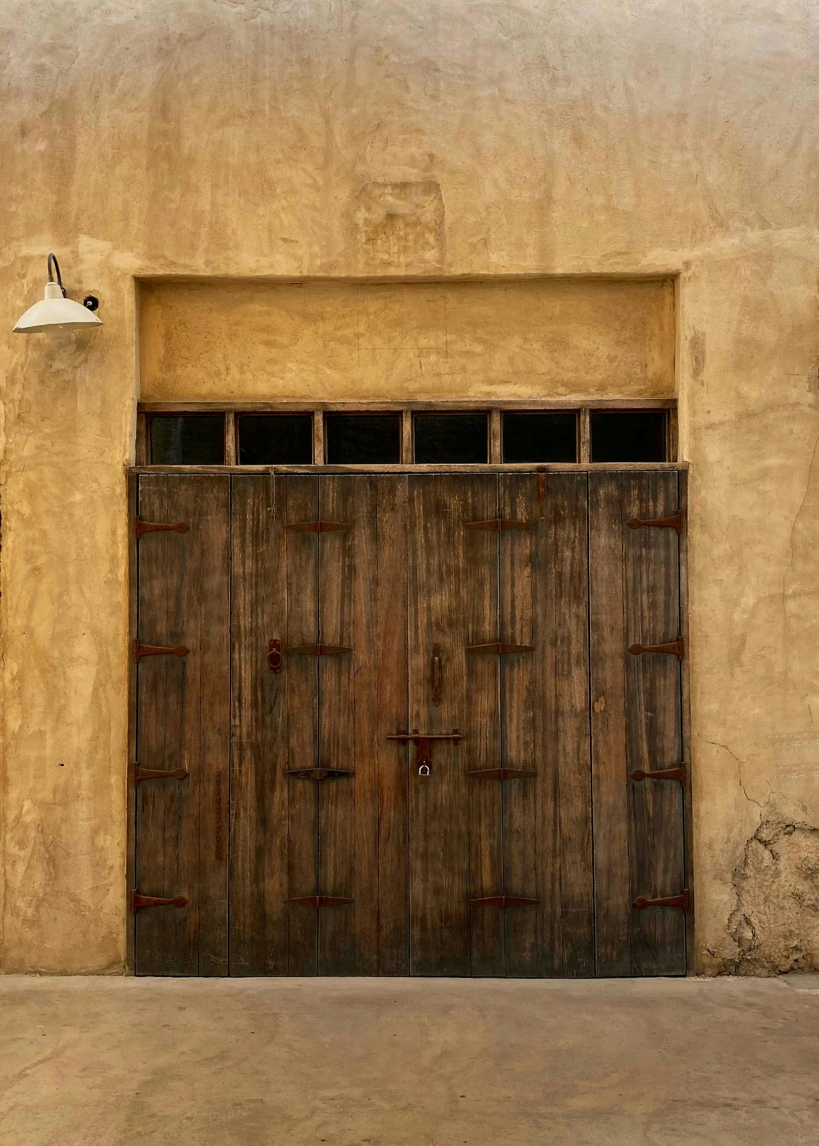 an old door with no glass sits next to a building