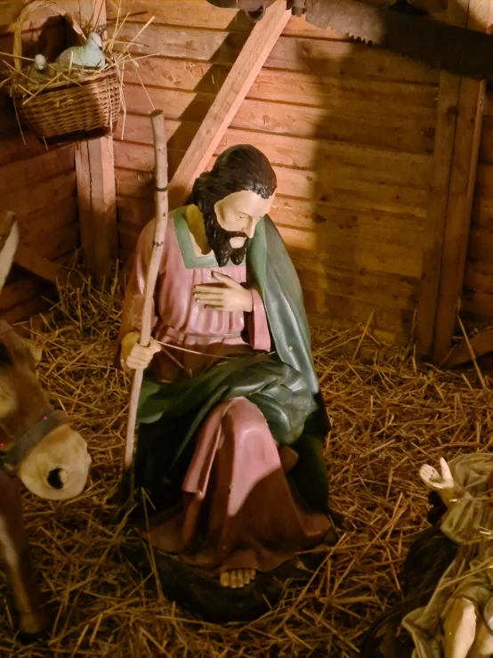 statue of mary with crib with two donkeys next to it