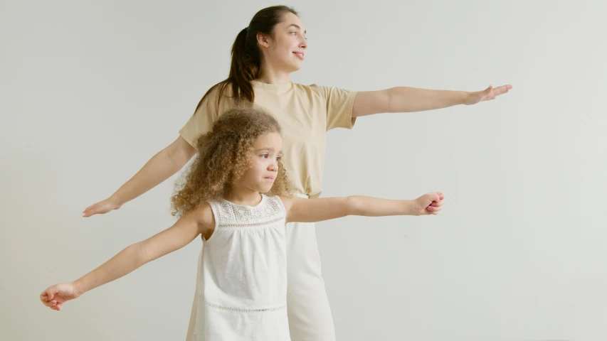 the woman holds on to her child's leg