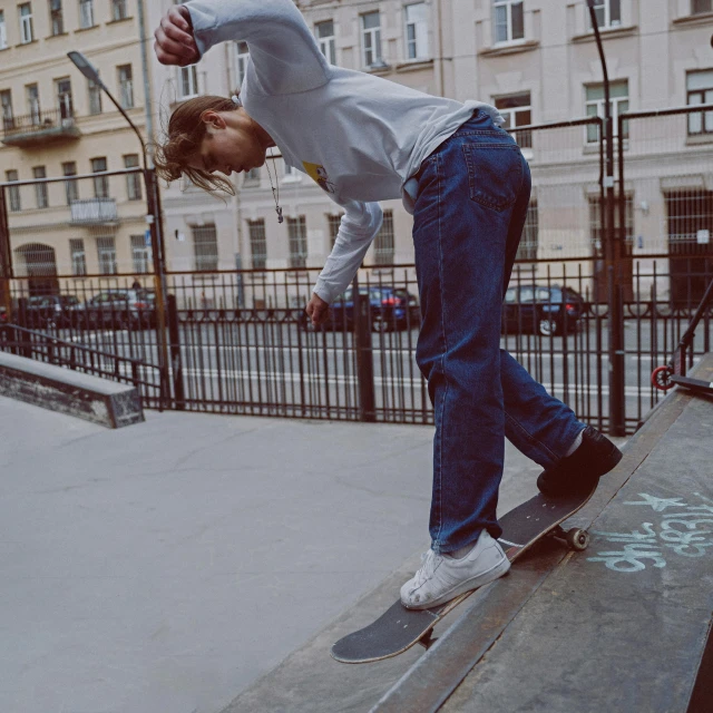 a  on a skateboard riding up the side of a ramp