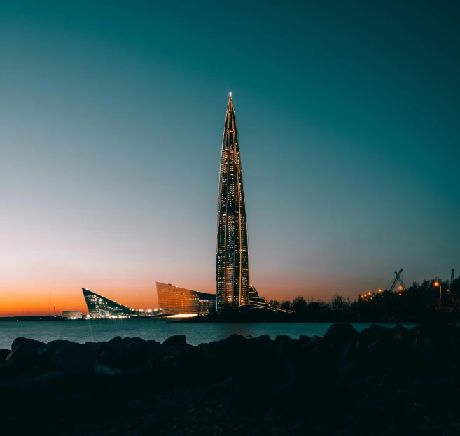 a long slender building by the sea at dusk