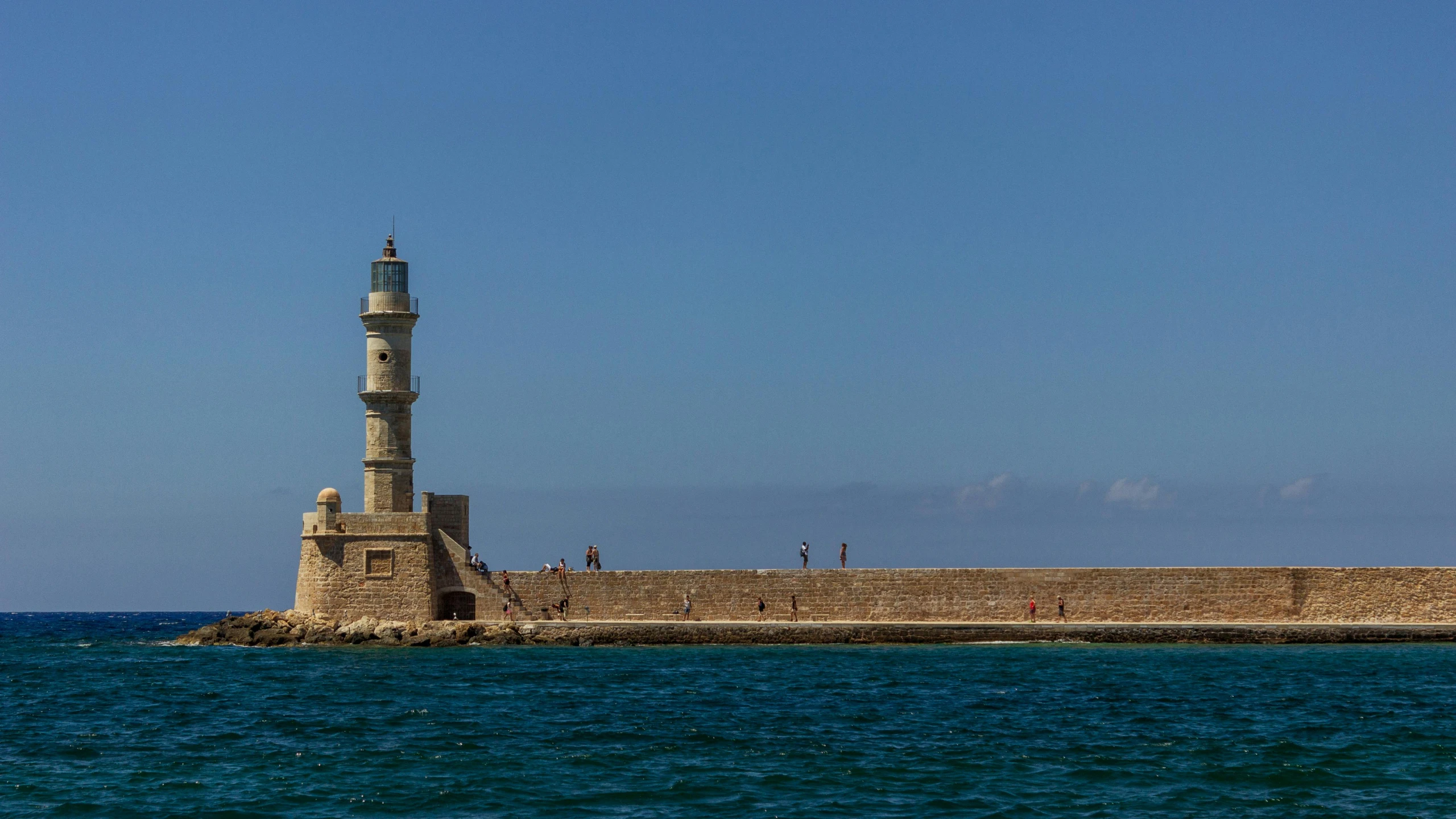 a light house sitting on top of a stone wall