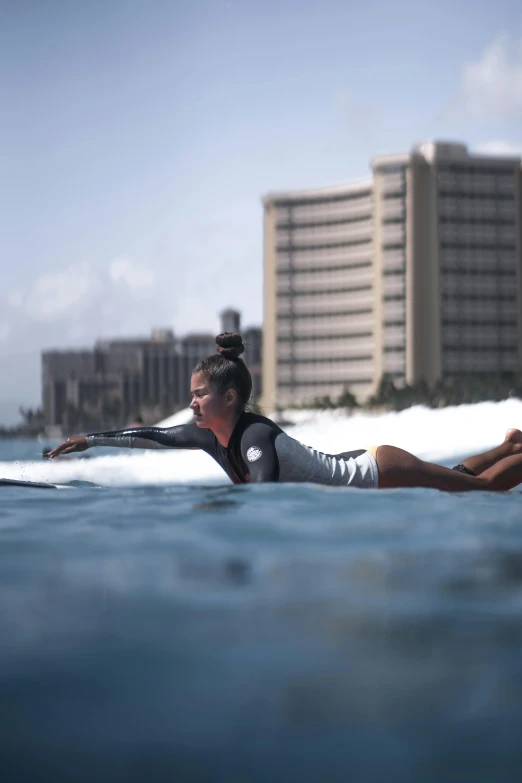 a  lying on a surfboard in the ocean