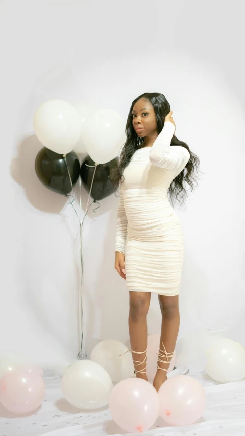 a beautiful woman posing with balloons and dresses