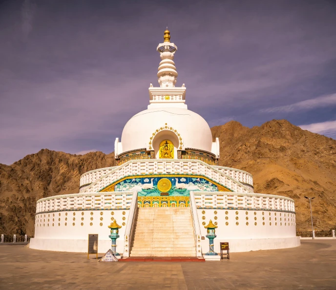 an outside white structure with stairs and a big dome on top