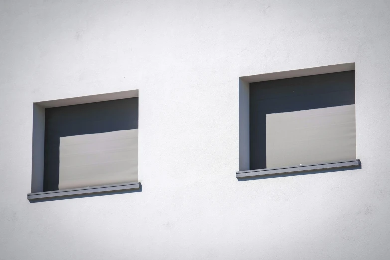 two windows sitting side by side against a wall