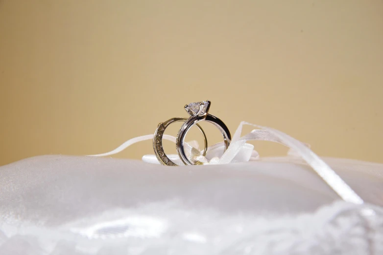 a couple of rings that are next to each other on some white cloth