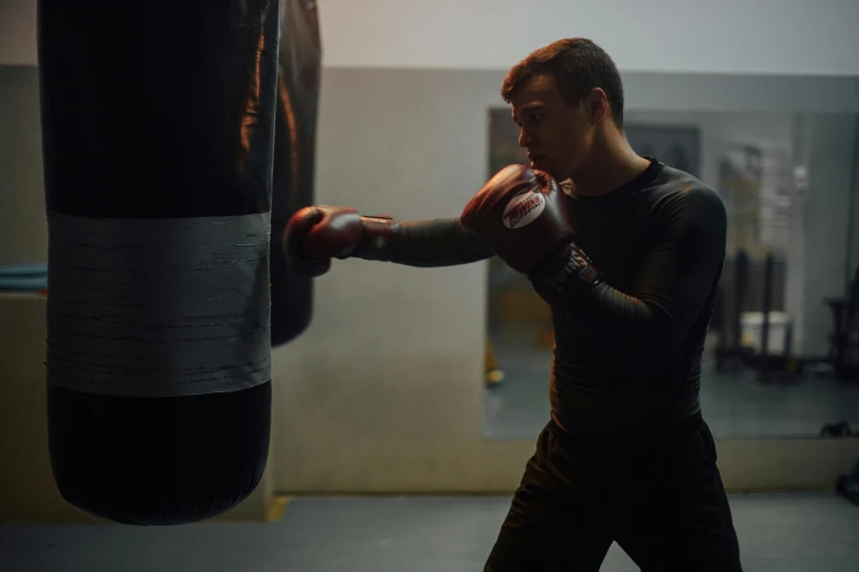 man practicing in a gym punching his hand