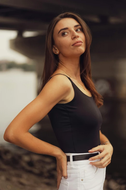 a girl with her hand on her hip looks up