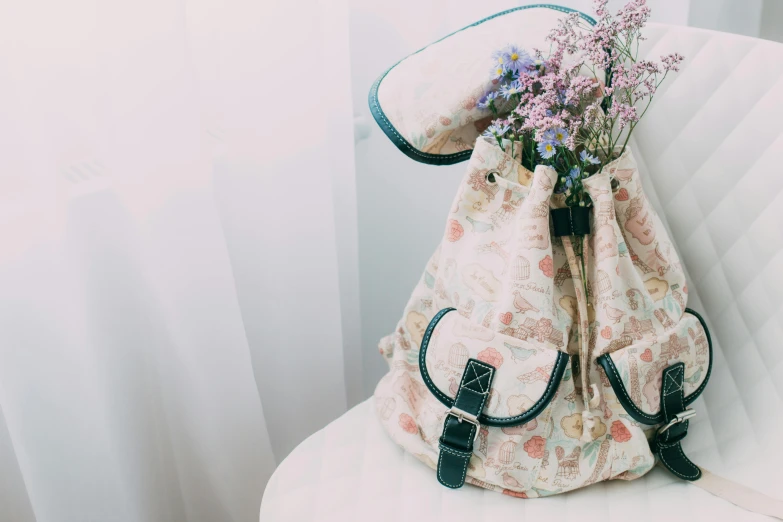 a backpack sitting on top of a white couch