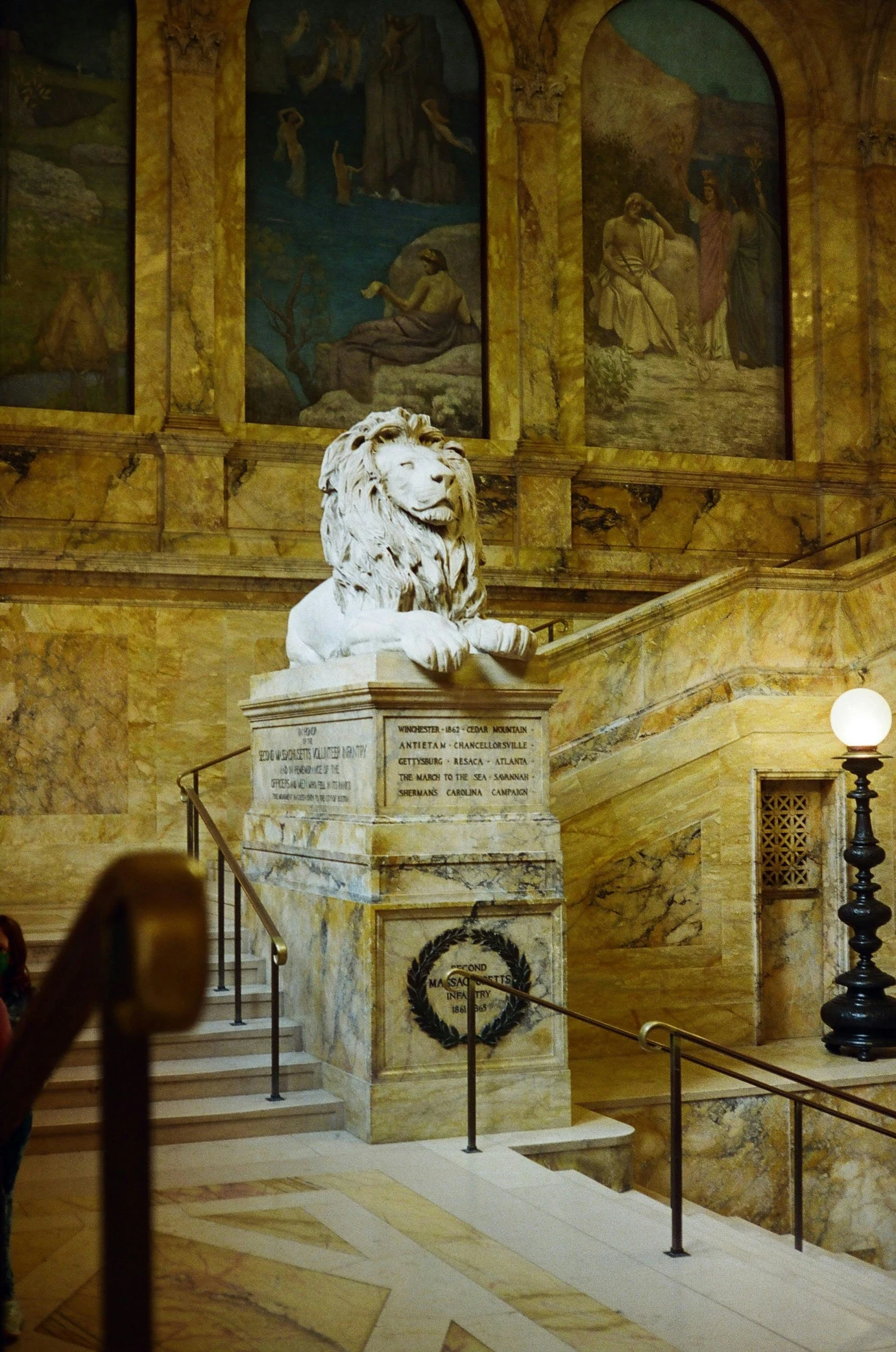 statue of lion and other paintings in room