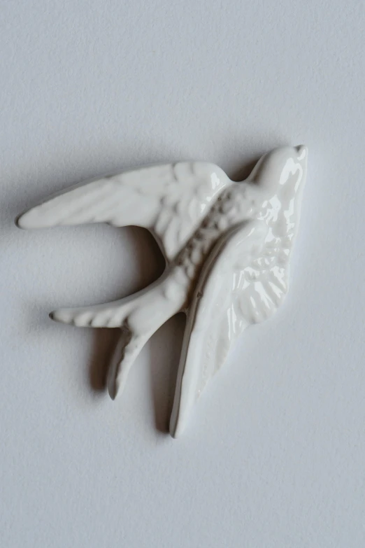 an angel's wing is shown against a gray background