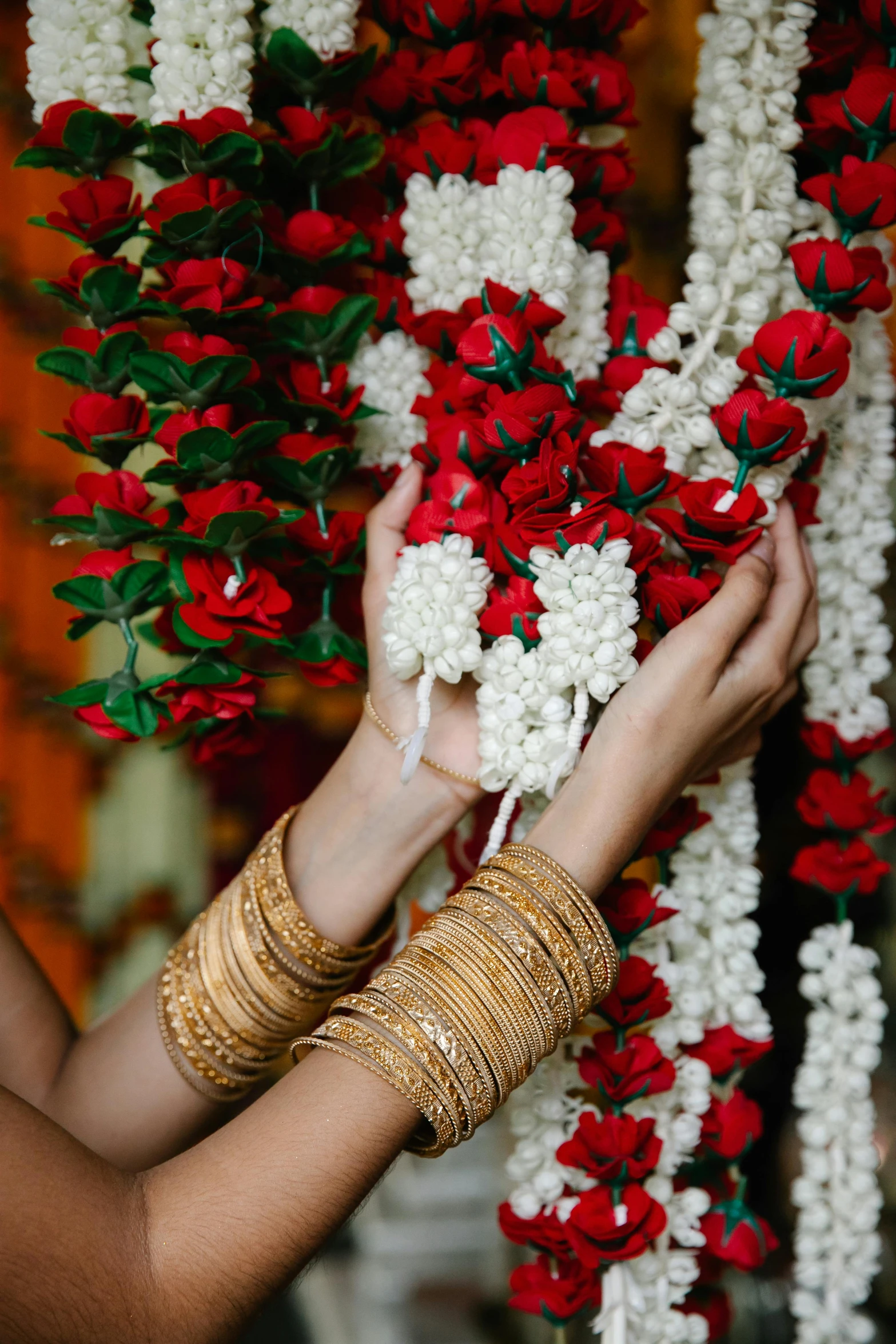 a woman wearing celets is holding flowers