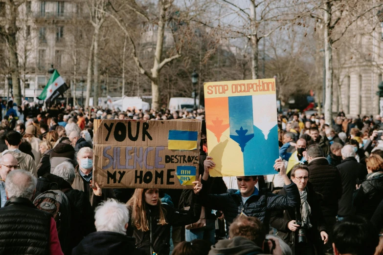 a group of people holding up signs on top of them